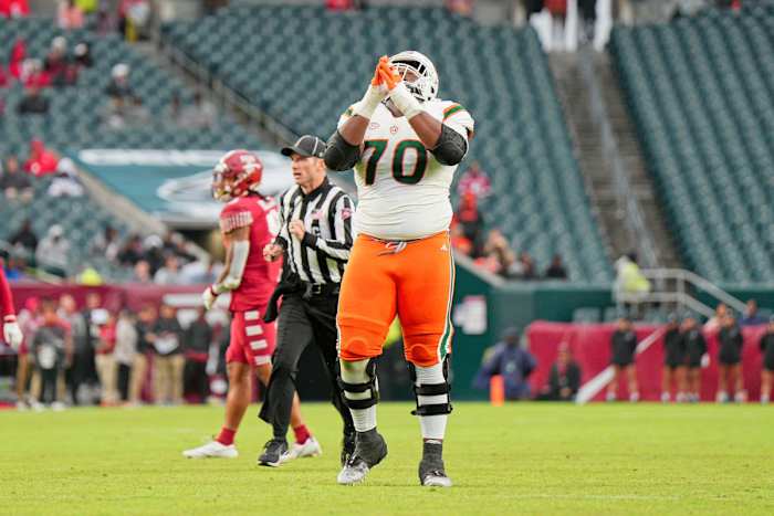 Miami Hurricanes offensive lineman Javion Cohen (70) celebrates a touchdown.